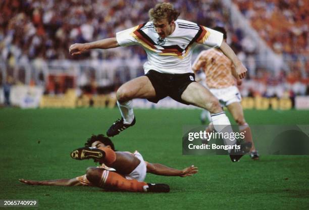Germany footballer Rudi Voller jumps clear of the challenge from Dutch footballer Frank Rijkaard during the UEFA Euro 1988 semifinal match between...