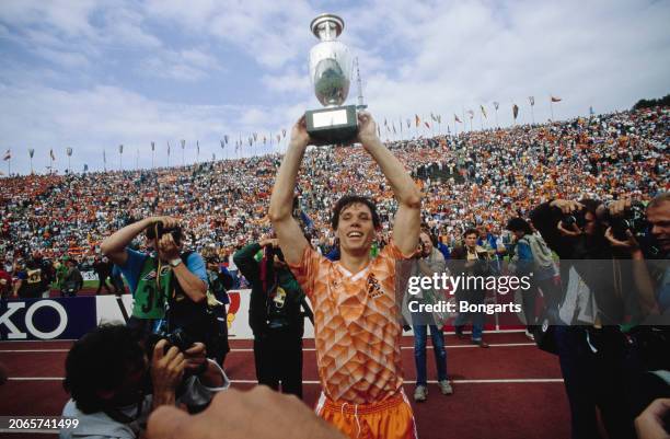 Dutch footballer Marco van Basten with the trophy after the UEFA Euro 1988 final between the Soviet Union and the Netherlands, held at Olympiastadion...