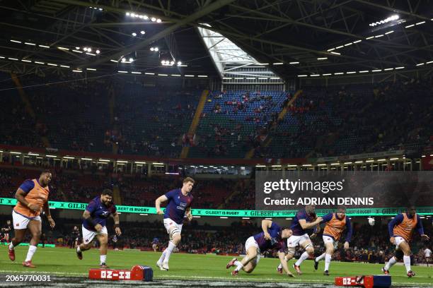 French players warm up under the closed roof ahead of the Six Nations international rugby union match between Wales and France at the Principality...