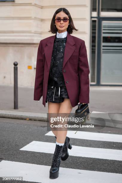 Heart Evangelista wears white shirt, black decorated jumper with matching ruffle mini skirt, burgundy Miu Miu blazer, black Miu Miu bag, black...