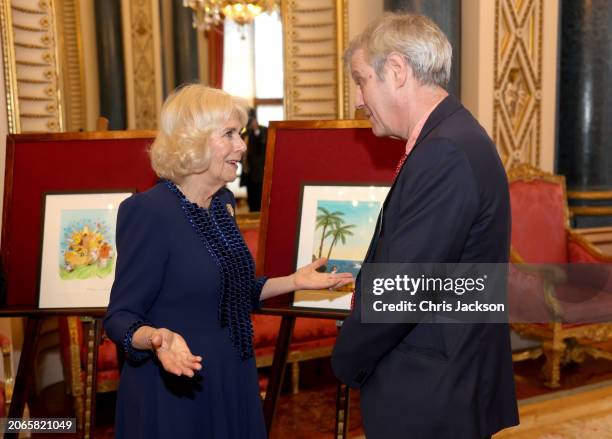 In this image released March 7, Queen Camilla speaks with illustrator Axel Scheffler during a reception for the BBC's 500 Words Finalists at...