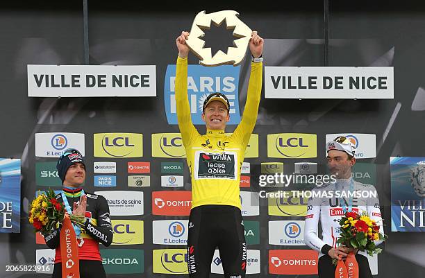 First placed Team Visma-Lease a Bike's US cyclist Matteo Jorgenson celebrates with the trophy on the podium after winning the 82nd edition of the...