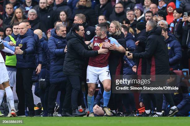 Aston Villa manager Unai Emery pushes John McGinn away from angry Tottenham players and towards the tunnel after he sent off for a foul during the...