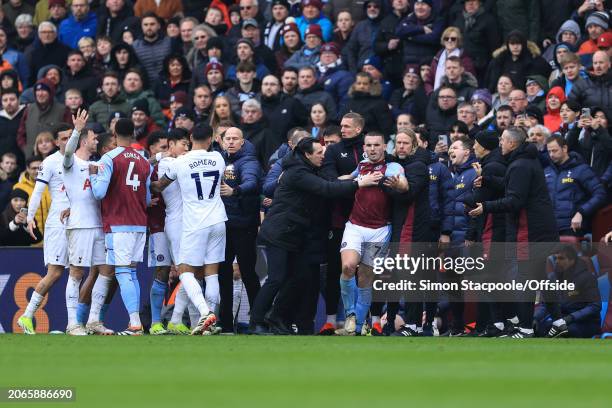 Aston Villa manager Unai Emery pushes John McGinn away from angry Tottenham players and towards the tunnel after he sent off for a foul during the...