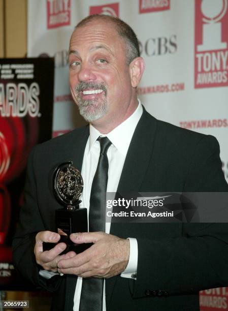 Musician Billy Joel poses backstage after winning win Best Orchestration for "Movin' Out" at the "57th Annual Tony Awards" at Radio City Music Hall...