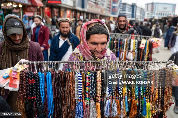 An Afghan vendor sells prayer beads at a market ahead of the Islamic holy month of Ramadan in Kabul on March 10, 2024.