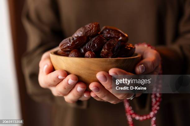 dates fruit in a wooden bowl - ramadan dates stock pictures, royalty-free photos & images