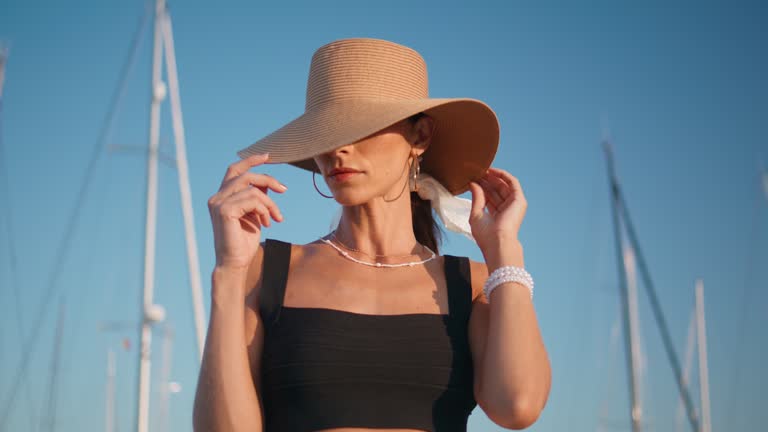 https://media.gettyimages.com/id/2065975438/video/elegant-hat-model-posing-in-front-yachts-masts-at-summer-embankment-close-up.jpg?b=1&s=640x640&k=20&c=rpDh9Hjj9C1VvnZUZOWFnapyzOAenIRi-wYZdfU5b6Q=