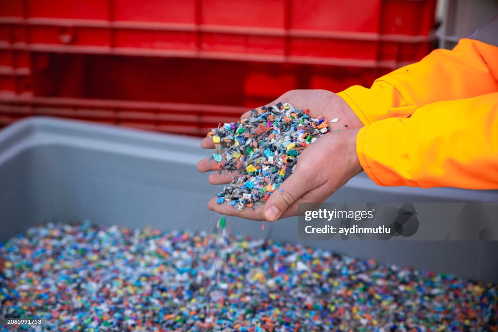 Plastic Resin pellets in holding hands.