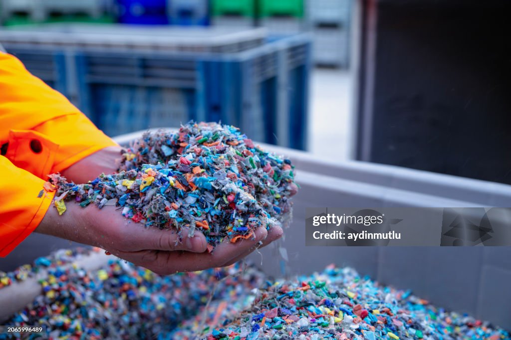 Plastic Resin pellets in holding hands.