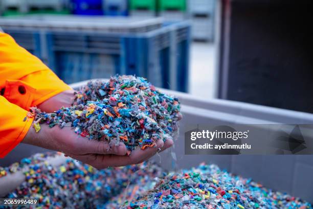 plastic resin pellets in holding hands. - pc foto e immagini stock