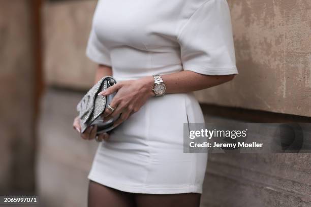 Fashion Week Guest seen wearing a white dress, Audemars Piguet silver and golden watch, Valentino silver shimmery handbag outside Valentino show...