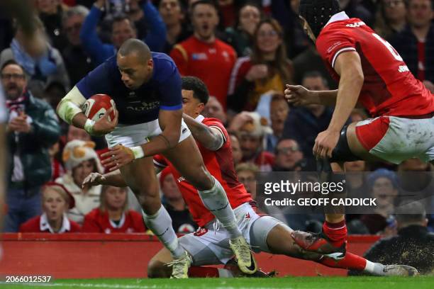 France's centre Gael Fickou dives for the line to score their first try during the Six Nations international rugby union match between Wales and...