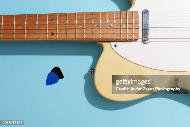 generic electric guitar on light blue background - country rock music stock pictures, royalty-free photos & images