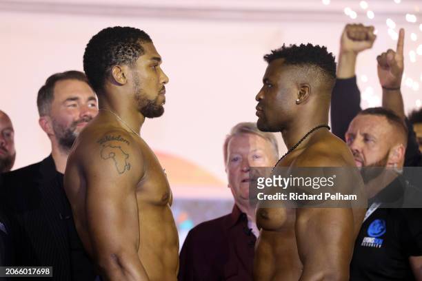 Anthony Joshua and Francis Ngannou face-off at the weigh-in ahead of their 'Knockout Chaos' heavyweight fight at Greece in Boulevard World on March...