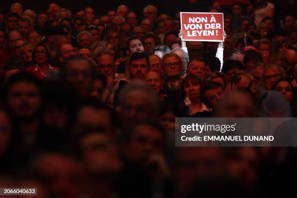 Person holds a placard reading "No to Von Der Leyen" during the European election campaign launch meeting of the far right "Reconquete!" party at Le...