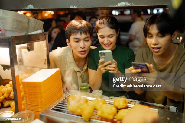 foodie enjoying food exploration at yaowarat night market. - youtiao stock pictures, royalty-free photos & images