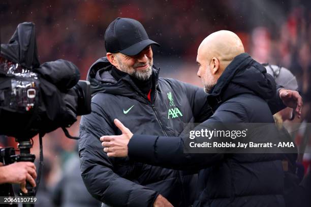 Jurgen Klopp, Manager of Liverpool, embraces Pep Guardiola, Manager of Manchester City, prior to the Premier League match between Liverpool FC and...