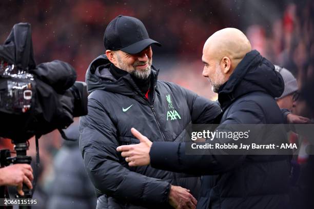 Jurgen Klopp, Manager of Liverpool, embraces Pep Guardiola, Manager of Manchester City, prior to the Premier League match between Liverpool FC and...