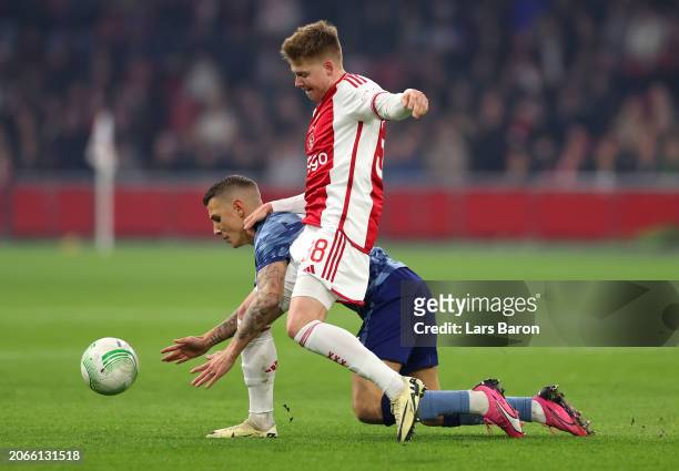 Lucas Digne of Aston Villa is challenged by Kristian Hlynsson of Ajax during the UEFA Europa Conference League 2023/24 round of 16 first leg match...
