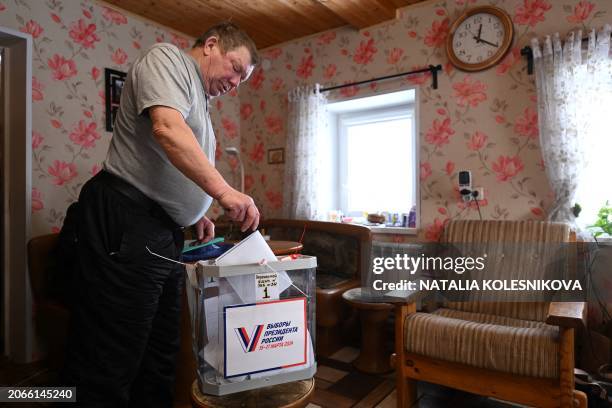 Man casts his ballot at his home during early voting for Russia's presidential election in the village of Yersenevo, Republic of Karelia, on March...