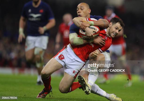 Wales' scrum-half Tomos Williams is tackled by France's centre Gael Fickou during the Six Nations international rugby union match between Wales and...