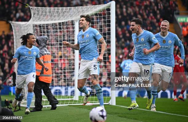 Manchester City's English defender John Stones celebrates scoring the opening goal during the English Premier League football match between Liverpool...