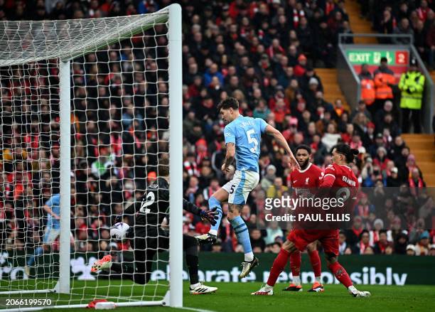Manchester City's English defender John Stones scores the opening goal during the English Premier League football match between Liverpool and...