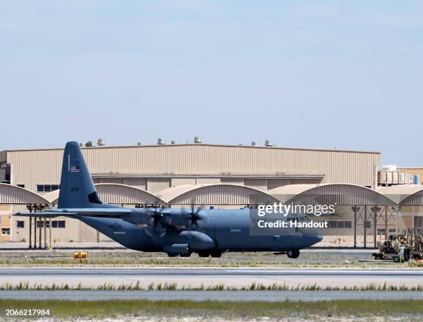 In this handout released by the U.S. AIr Force, A U.S. Air Force C-130J Super Hercules aircraft loaded with humanitarian aid bound for airdrop over...