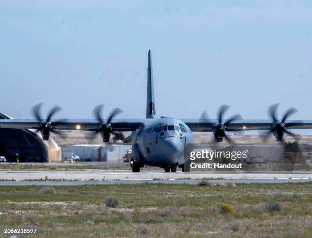 In this handout released by the U.S. AIr Force, A U.S. Air Force C-130J Super Hercules aircraft loaded with humanitarian aid bound for airdrop over...