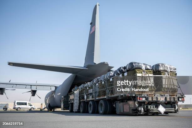 In this handout released by the U.S. AIr Force, A U.S. Air Force K-loader filled with pallets of Halal meals destined for an airdrop over Gaza are...
