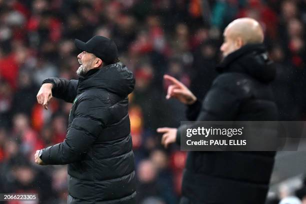 Liverpool's German manager Jurgen Klopp and Manchester City's Spanish manager Pep Guardiola shouts instructions to the players from the touchline...