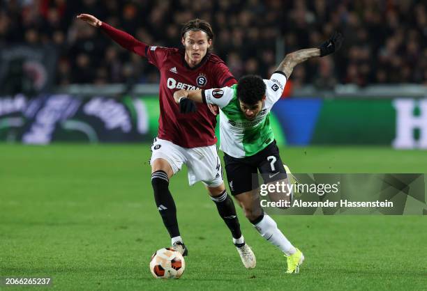 Luis Diaz of Liverpool is challenged by Markus Solbakken of Sparta Prague during the UEFA Europa League 2023/24 round of 16 first leg match between...