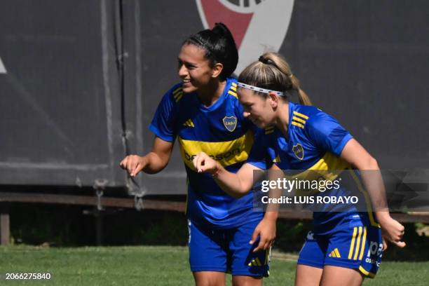 Boca Junior's defender Eliana Stabile celebrates with teammates midfielder Camila Gomez a goal against River Plate during the Argentine women's...