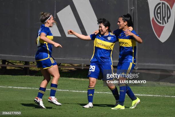 Boca Junior's defender Eliana Stabile celebrates with teammates midfielder Camila Gomez and Sasaki Yuria a goal against River Plate during the...