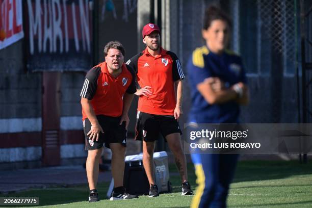 River Plate's coach Cristian Kolisek and coach Ignacio Lacal give instructions to their players during the Argentine women's professional football...