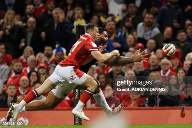 France's prop Romain Taofifenua and Wales' scrum-half Gareth Davies chase the ball over the Welsh try-line, Taofifenua managed to score, during the...