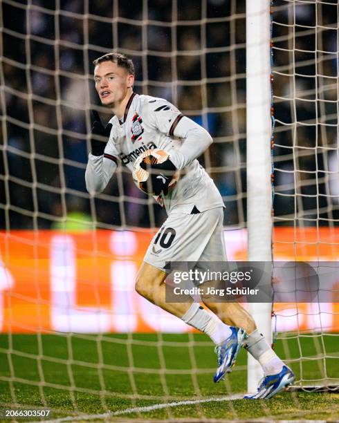 Florian Wirtz of Leverkusen celebrates after scoring his teams first goal during the UEFA Europa League 2023/24 round of 16 first leg match between...