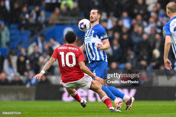 Lewis Dunk of Brighton &amp; Hove Albion is under pressure from Morgan Gibbs-White of Nottingham Forest during the Premier League match between...