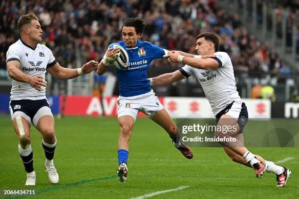 Duhan van der Merwe of Scotland, Ange Capuozzo of Italy and Cameron Redpath of Scotland compete for the ball during the Six Nations rugby match...