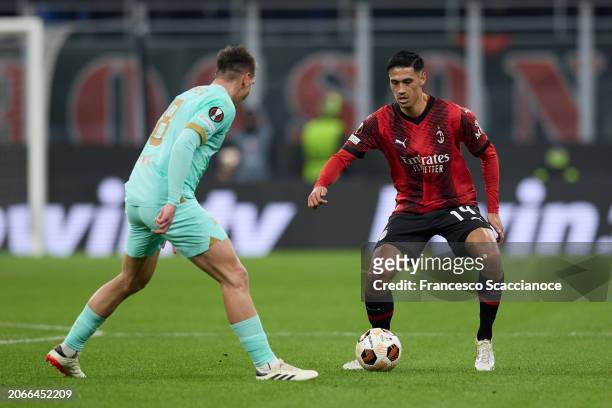 Tijjani Reijnders of AC Milan in action is challenged by Lukas Masopust of Slavia Praha during the UEFA Europa League 2023/24 round of 16 first leg...