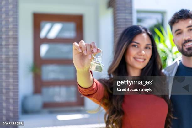 close up happy woman and man, holding keys from new first house, young family celebrating moving day, - home renovations australia stock-fotos und bilder