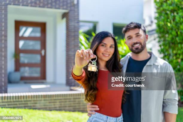 close up happy woman and man, holding keys from new first house, - home renovations australia stock-fotos und bilder