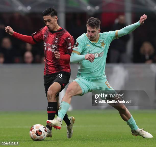 Tijjani Reijnders of AC Milan battles for the ball with Lukas Masopust of SK Slavia Praha during the UEFA Europa League 2023/24 round of 16 first leg...