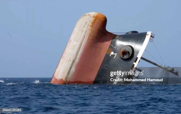 This handout photo provided by Yemeni Al-Joumhouria TV, shows the British-registered cargo ship 'Rubymar' sinking after it was targeted by Yemen's...