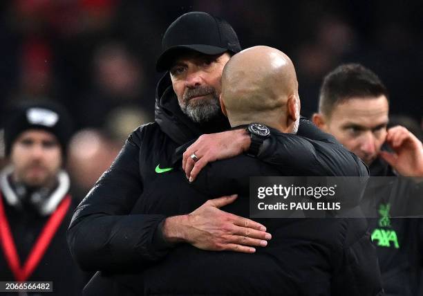 Liverpool's German manager Jurgen Klopp embraces Manchester City's Spanish manager Pep Guardiola at the end of the English Premier League football...