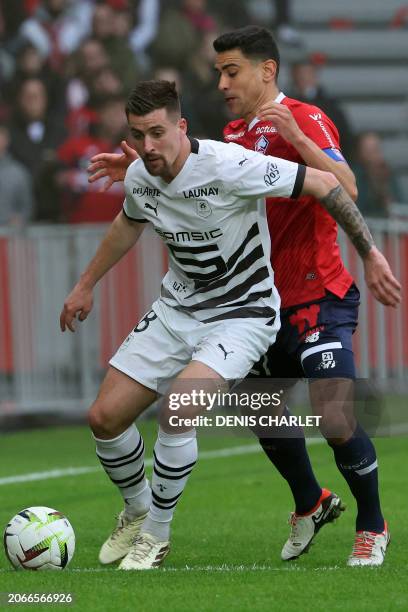 Rennes' French midfielder Baptiste Santamaria fights for the ball with Lille's Kosovar midfielder Edon Zhegrova during the French L1 football match...