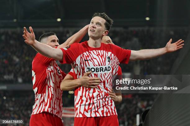 Michael Gregoritsch of SC Freiburg celebrates scoring his team's first goal during the UEFA Europa League 2023/24 round of 16 first leg match between...