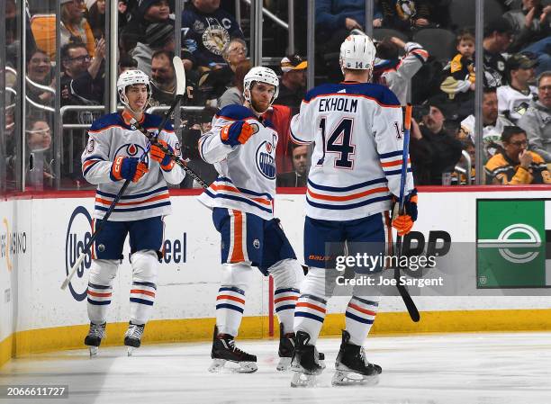 Connor McDavid of the Edmonton Oilers celebrates his goal with teammates during the first period against the Pittsburgh Penguins at PPG PAINTS Arena...