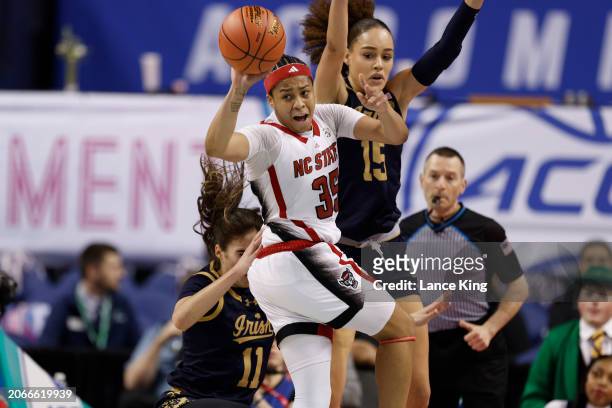 Zoe Brooks of the NC State Wolfpack looks to pass against Natalija Marshall of the Notre Dame Fighting Irish during the first half of the ACC Women's...